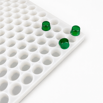 Close-up of a 3mL gumdrop gummy mold with 262 cavities and emerald green gummies on a white background