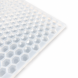 Close-up of a 3mL hexagon gem gummy mold with 263 cavities on a white background